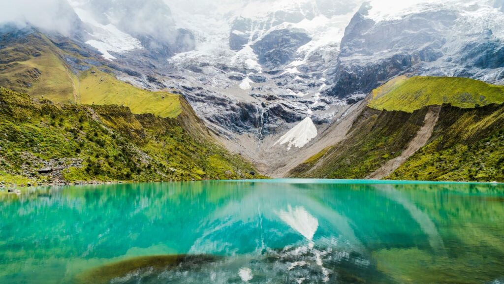 pexels-photo-22484292 A serene lake reflecting snowcapped mountains, showcasing pristine natural landscapes.